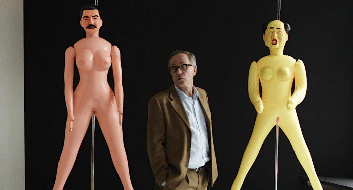 Fabrice Luchini between blow-up dollies of Stalin and Mao in In the House