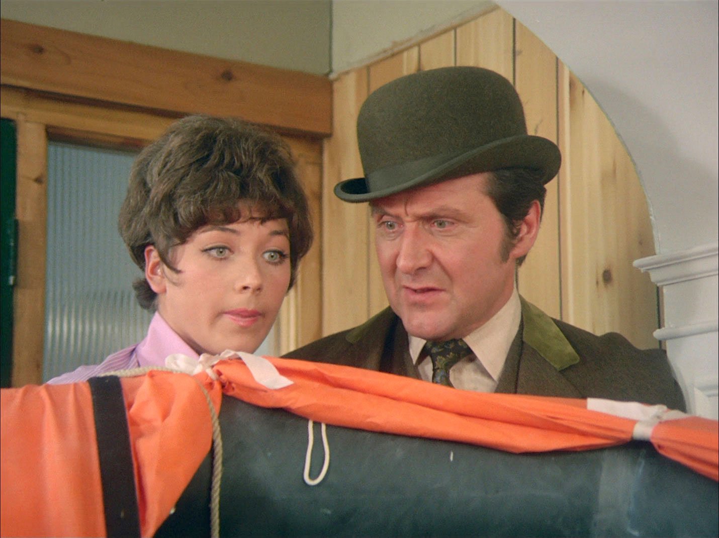 Tara King and John Steed examine a clue